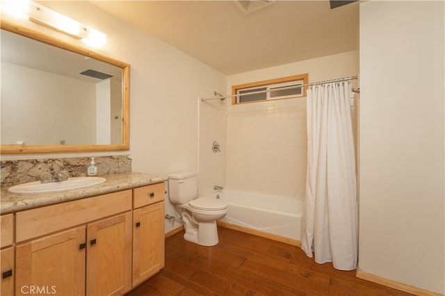 full bathroom with hardwood / wood-style flooring, vanity, toilet, and shower / bath combination with curtain