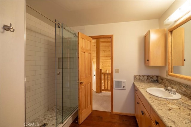 bathroom featuring vanity, hardwood / wood-style floors, and an enclosed shower