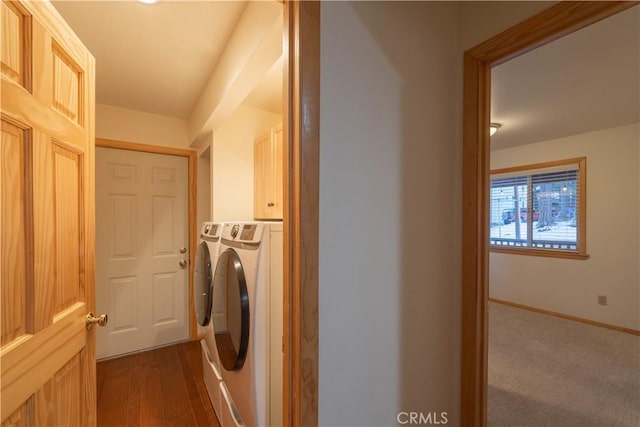 laundry room with dark hardwood / wood-style flooring, cabinets, and washing machine and clothes dryer