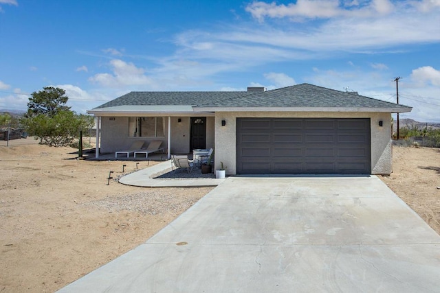 view of front of property featuring a garage and a porch