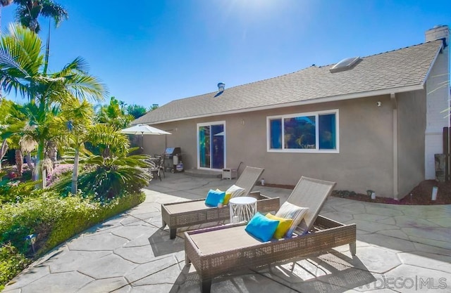 back of house with a patio