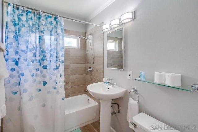 bathroom featuring shower / tub combo and toilet