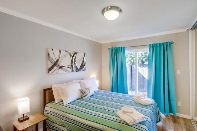 bedroom featuring ornamental molding and hardwood / wood-style floors