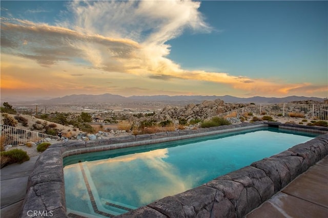 pool at dusk with a mountain view