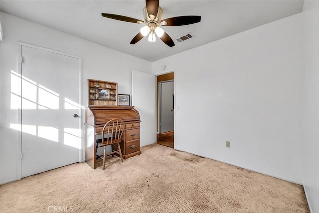 office area featuring light carpet and ceiling fan