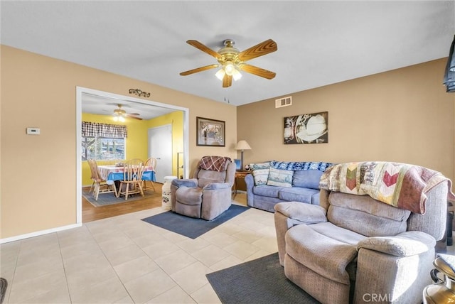 living room with ceiling fan and light tile patterned floors