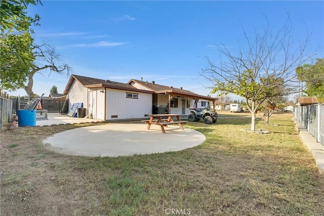 back of property featuring a patio and a yard