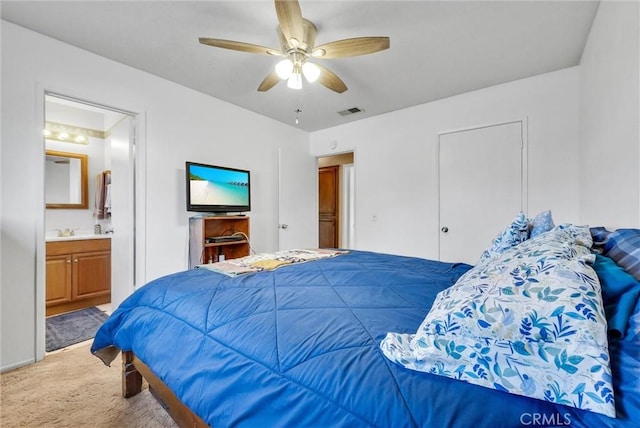 carpeted bedroom featuring sink, ceiling fan, and ensuite bathroom