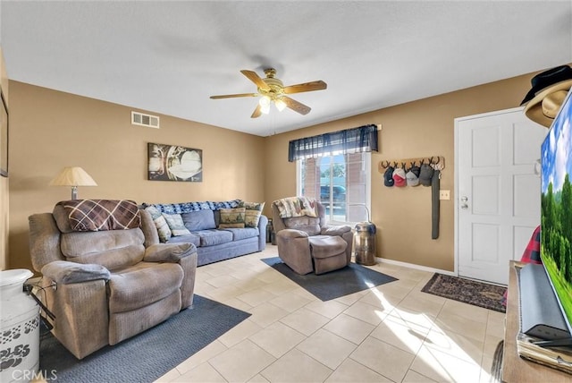 living room with ceiling fan and light tile patterned floors