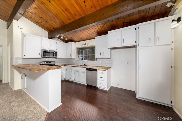 kitchen featuring vaulted ceiling with beams, decorative backsplash, appliances with stainless steel finishes, wooden ceiling, and a peninsula