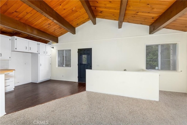 interior space with wood ceiling, dark wood finished floors, and vaulted ceiling with beams