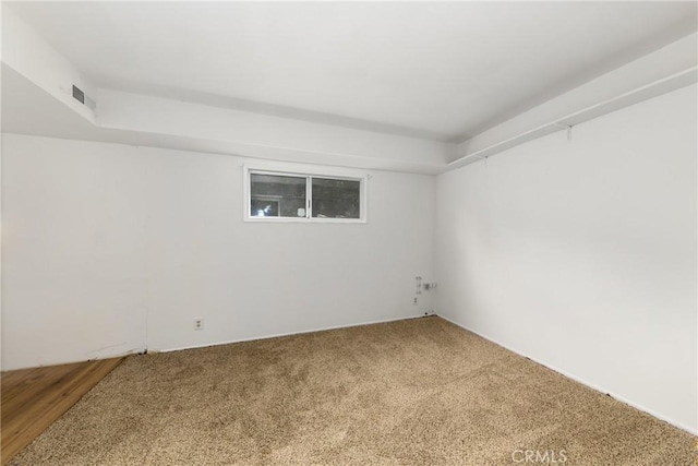 empty room with carpet and visible vents