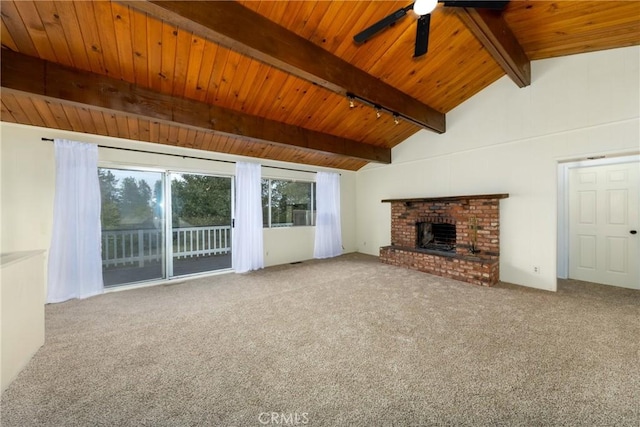 unfurnished living room with a ceiling fan, carpet floors, lofted ceiling with beams, wooden ceiling, and a brick fireplace