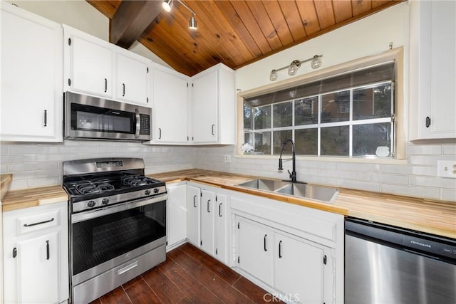 kitchen featuring a sink, wood ceiling, appliances with stainless steel finishes, wood counters, and tasteful backsplash