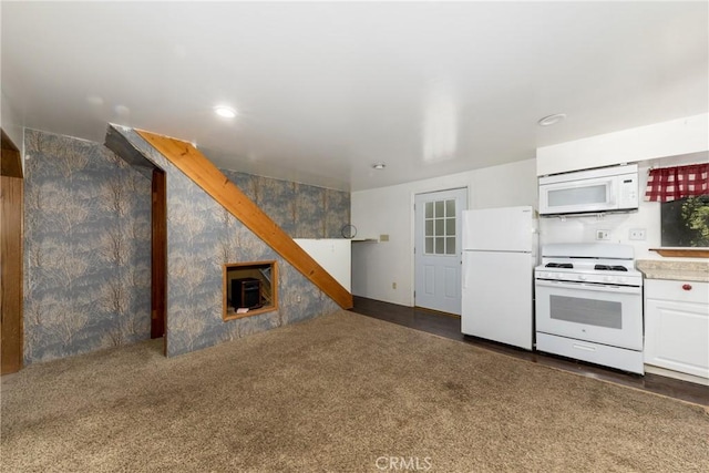 kitchen featuring white cabinetry, white appliances, light countertops, and dark colored carpet