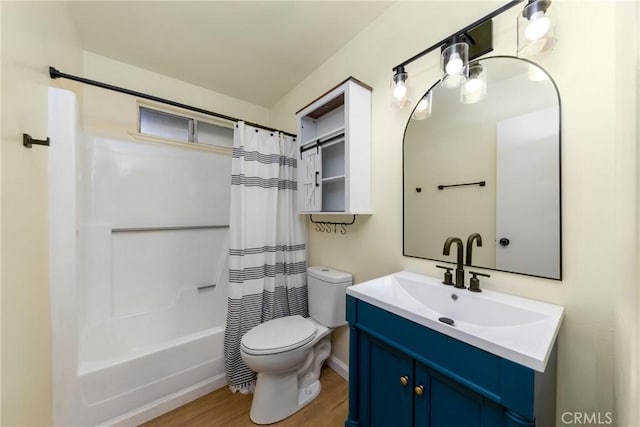 bathroom featuring shower / tub combo with curtain, toilet, wood finished floors, and vanity