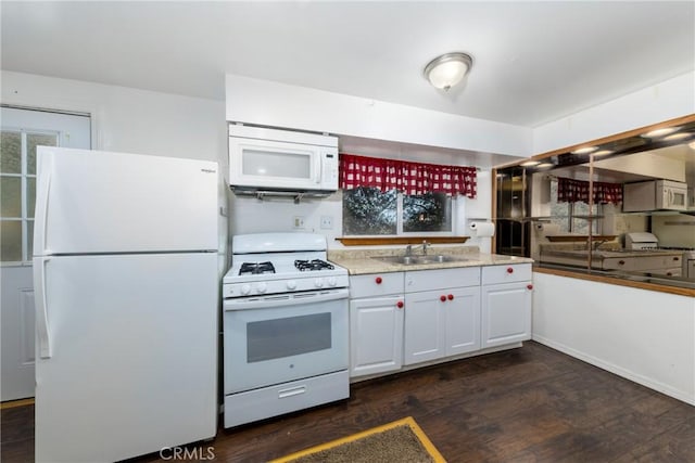 kitchen with dark wood-type flooring, a sink, white cabinetry, white appliances, and light countertops