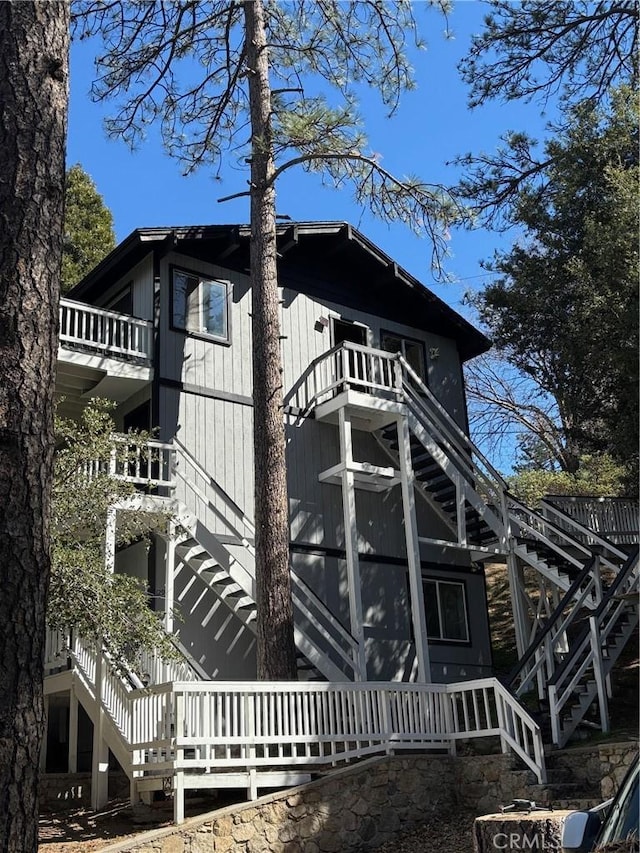 exterior space with stairway and a balcony