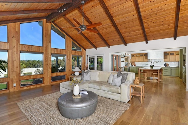 living room featuring high vaulted ceiling, beam ceiling, wooden ceiling, and light hardwood / wood-style floors