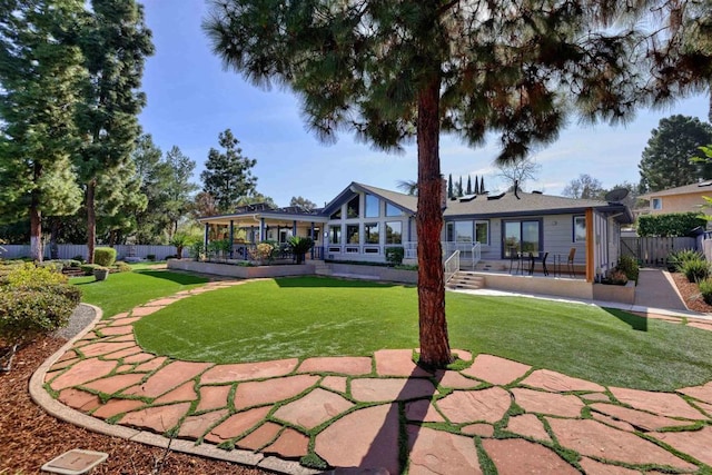 rear view of property featuring a yard and a patio