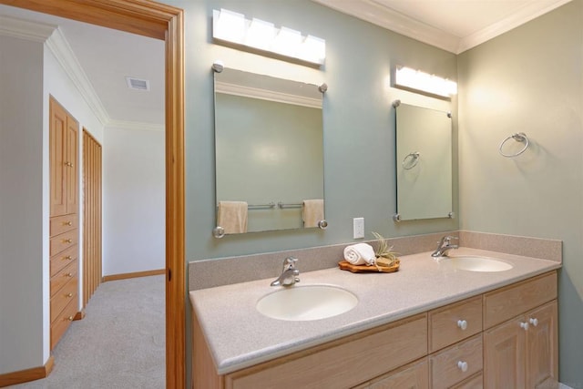 bathroom featuring ornamental molding and vanity