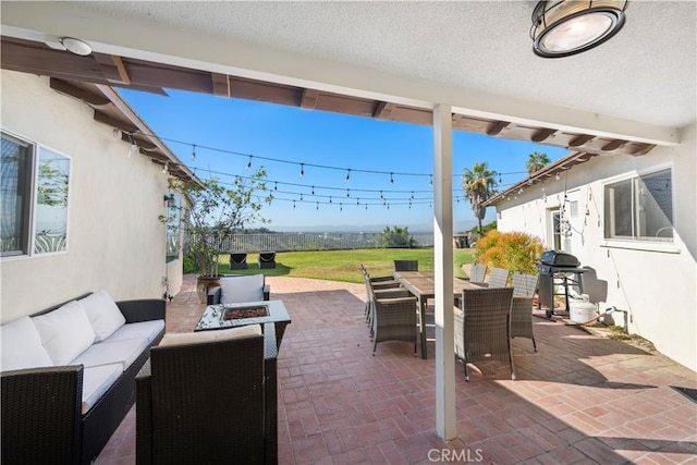 view of patio / terrace with a grill and an outdoor living space with a fire pit