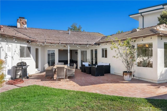 back of house featuring an outdoor hangout area, a lawn, and a patio area