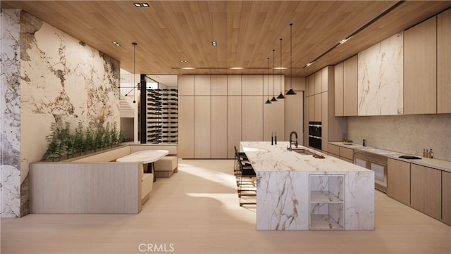 interior space featuring sink, wood ceiling, hanging light fixtures, a large island with sink, and light stone countertops