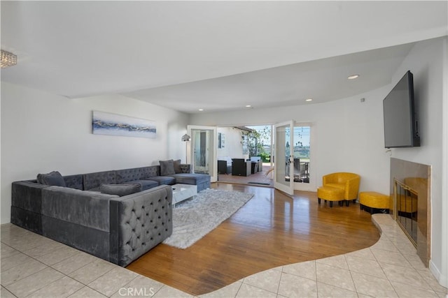 living room with a fireplace and light wood-type flooring