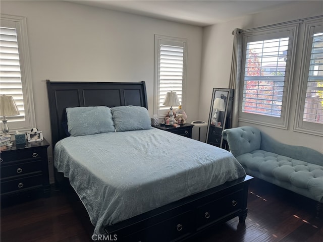 bedroom with dark wood-type flooring