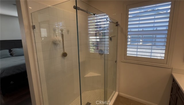 bathroom featuring vanity, tile patterned floors, and walk in shower