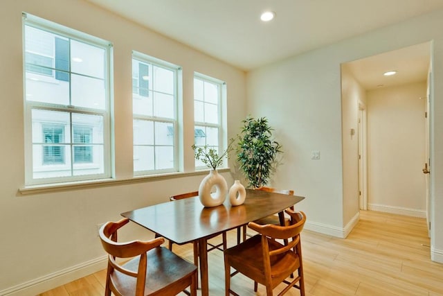 dining space with light hardwood / wood-style flooring