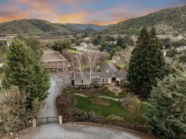 aerial view at dusk featuring a mountain view