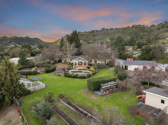 aerial view at dusk featuring a mountain view