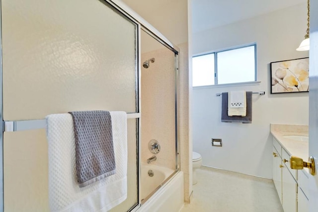 full bathroom featuring vanity, combined bath / shower with glass door, and toilet