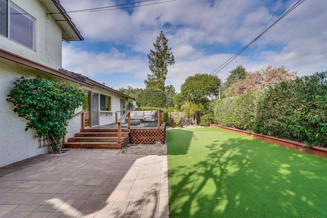 view of yard with an outdoor hangout area, a patio area, and a deck