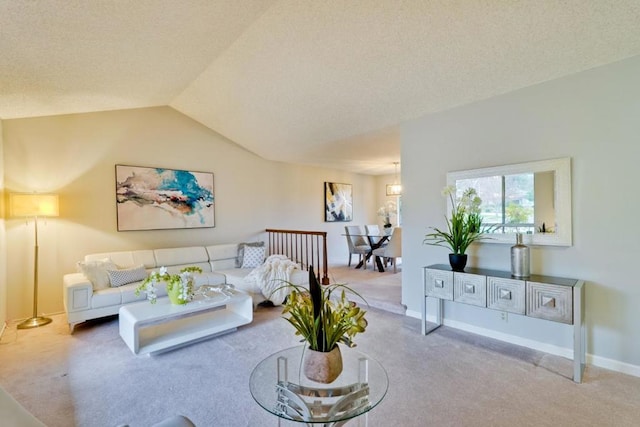 living room featuring lofted ceiling, carpet floors, and a textured ceiling