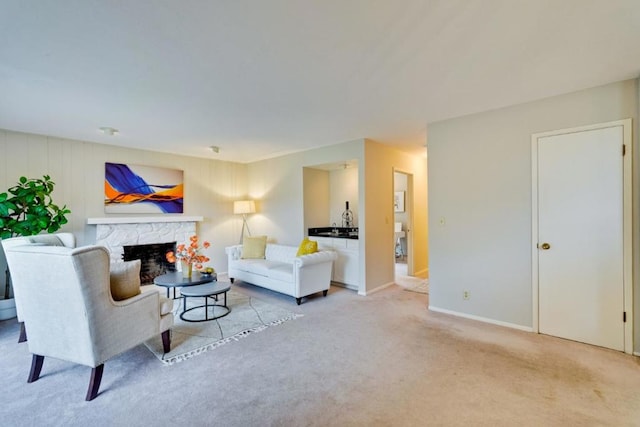 living room featuring light carpet and a fireplace