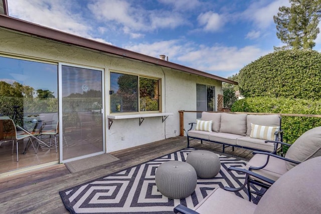 exterior space with an outdoor hangout area and a deck