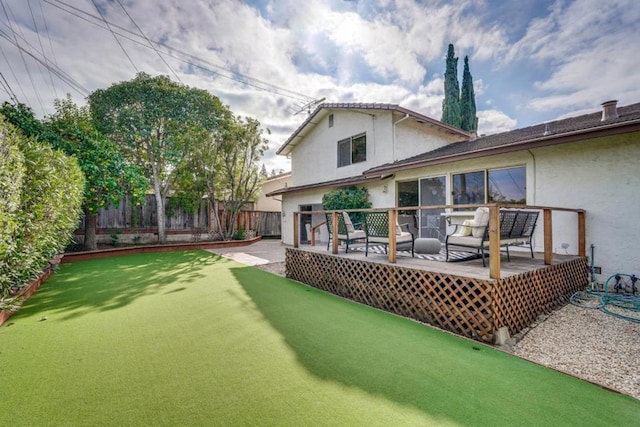 rear view of house featuring a wooden deck