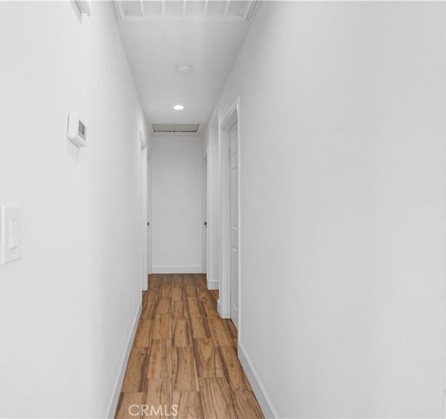 hall with hardwood / wood-style flooring