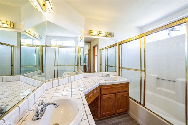 bathroom with vanity, combined bath / shower with glass door, and wood-type flooring