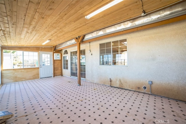 unfurnished sunroom with wood ceiling