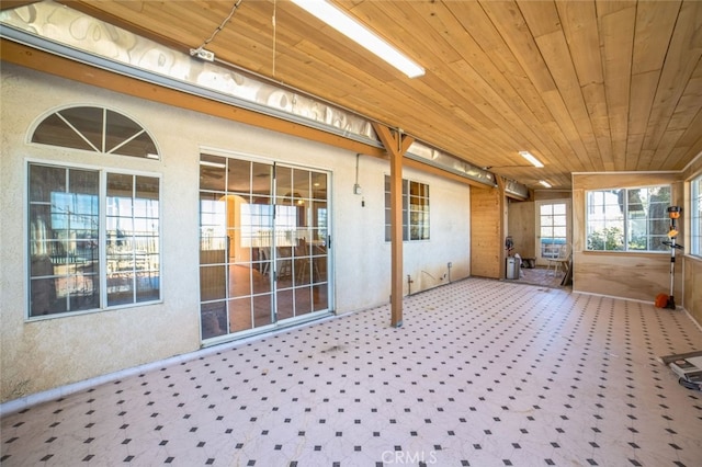 unfurnished sunroom featuring wood ceiling