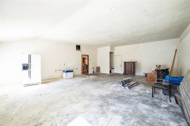 interior space with lofted ceiling and concrete flooring