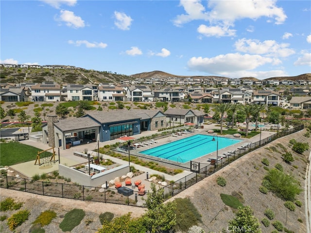 view of swimming pool featuring a mountain view and a patio