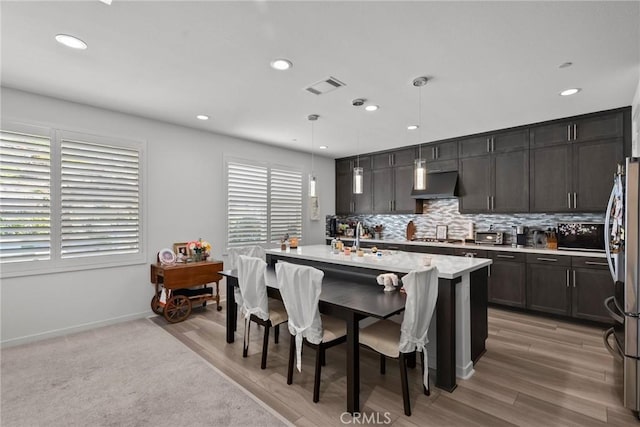 dining space featuring sink and light wood-type flooring