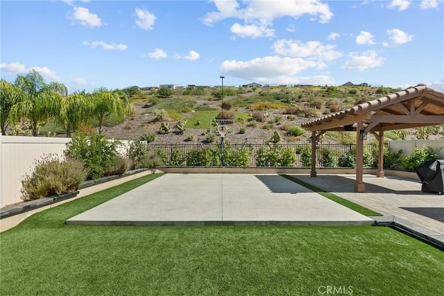 view of community featuring a lawn and a patio area