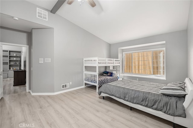 bedroom featuring vaulted ceiling with beams, light hardwood / wood-style flooring, and ceiling fan