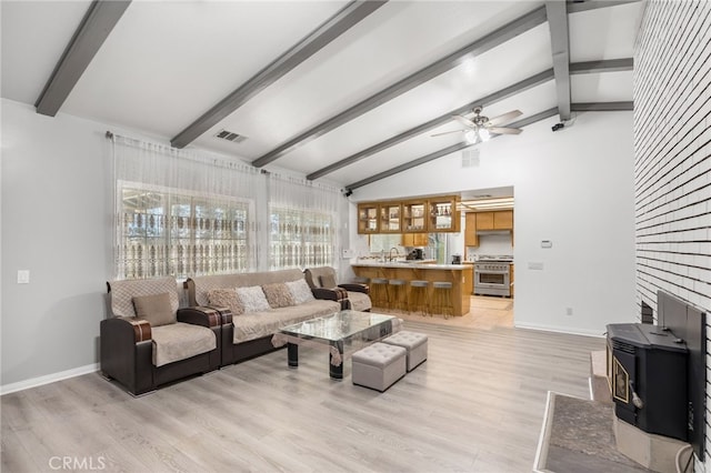 living room with lofted ceiling with beams, ceiling fan, sink, and light hardwood / wood-style floors